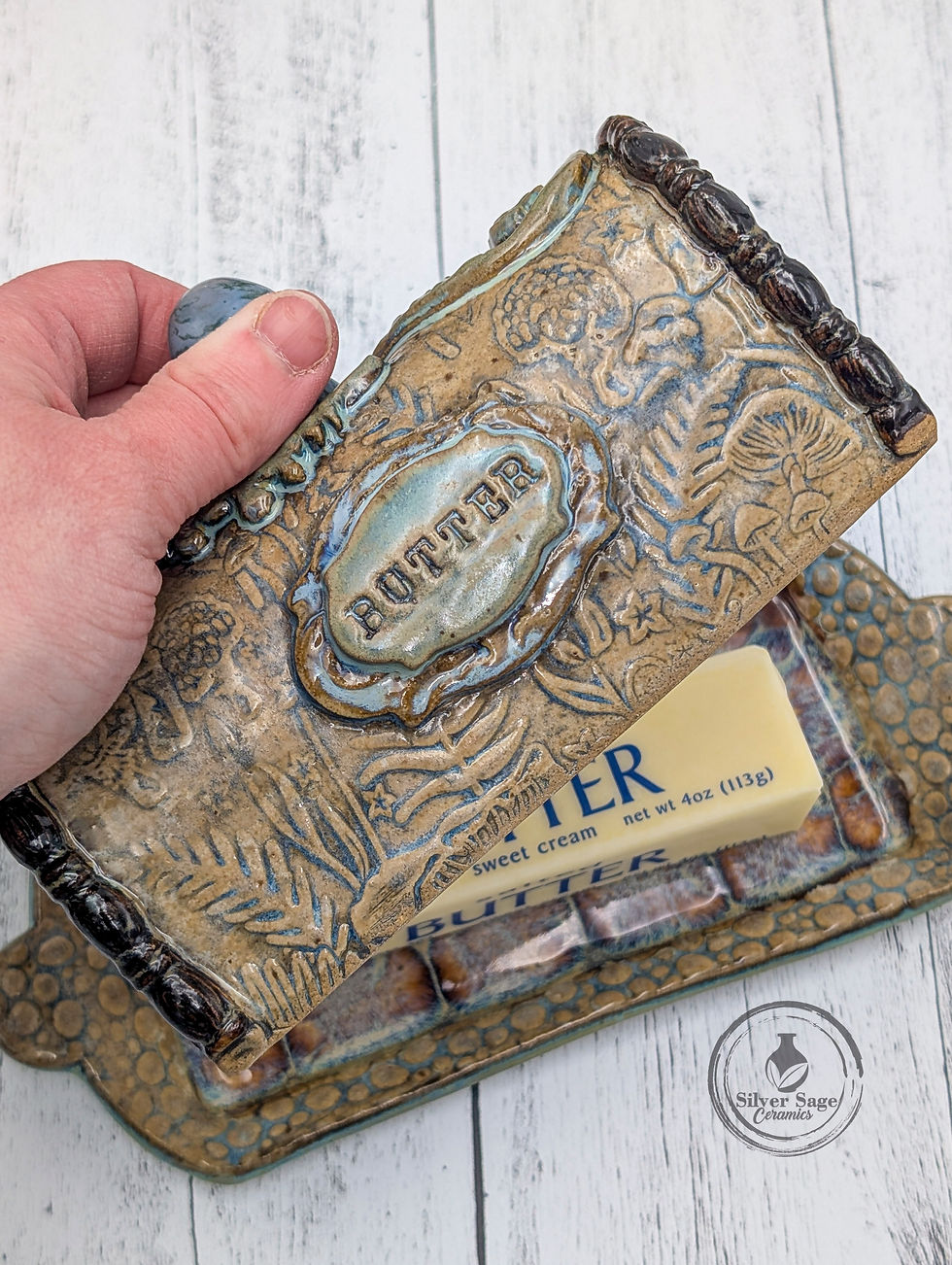 Close-up of blue howlite mushroom knob on handmade butter keeper