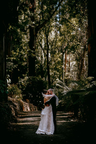 Bride and groom intimate embrace in rainforest wedding photography