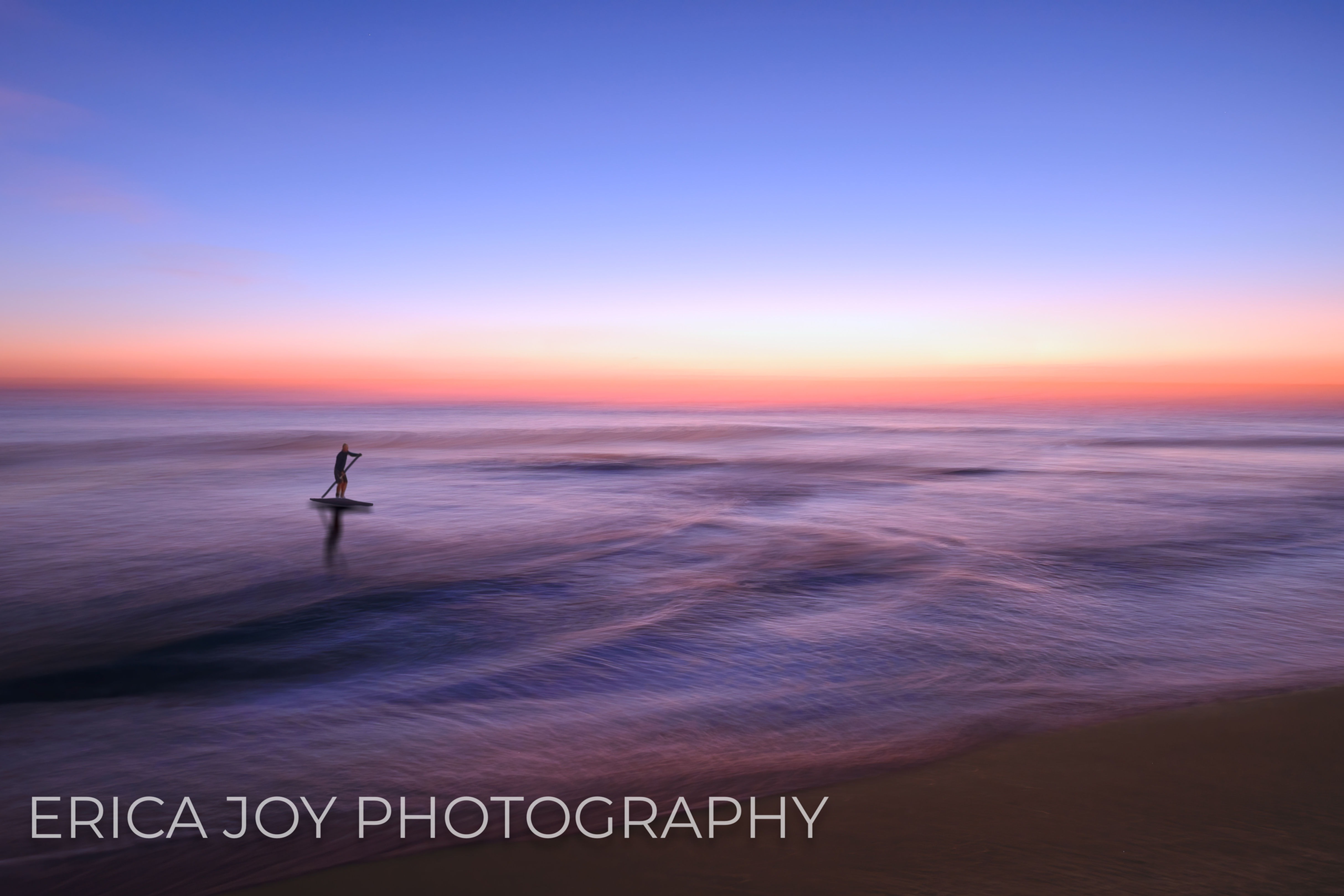 Paddle boarders at sunrise on Delray Beach in Florida