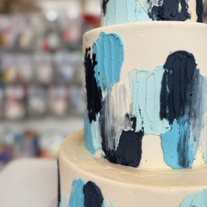 Three tier blue smudged wedding cake, close up