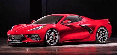 Eye-level view of a red Corvette parked against a desert backdrop