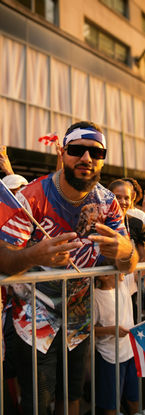 Man holding Puerto Rican flag at street parade