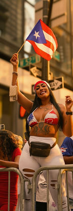 Woman waving Puerto Rican flag during the 2024 National Puerto Rican Day Parade. Photography by Rafael Mercedes.