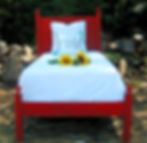 Red Twin Farmhouse Bed with woods in the background