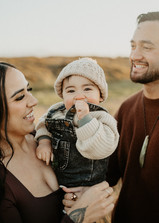 giggly toddler, playful parents and golden light