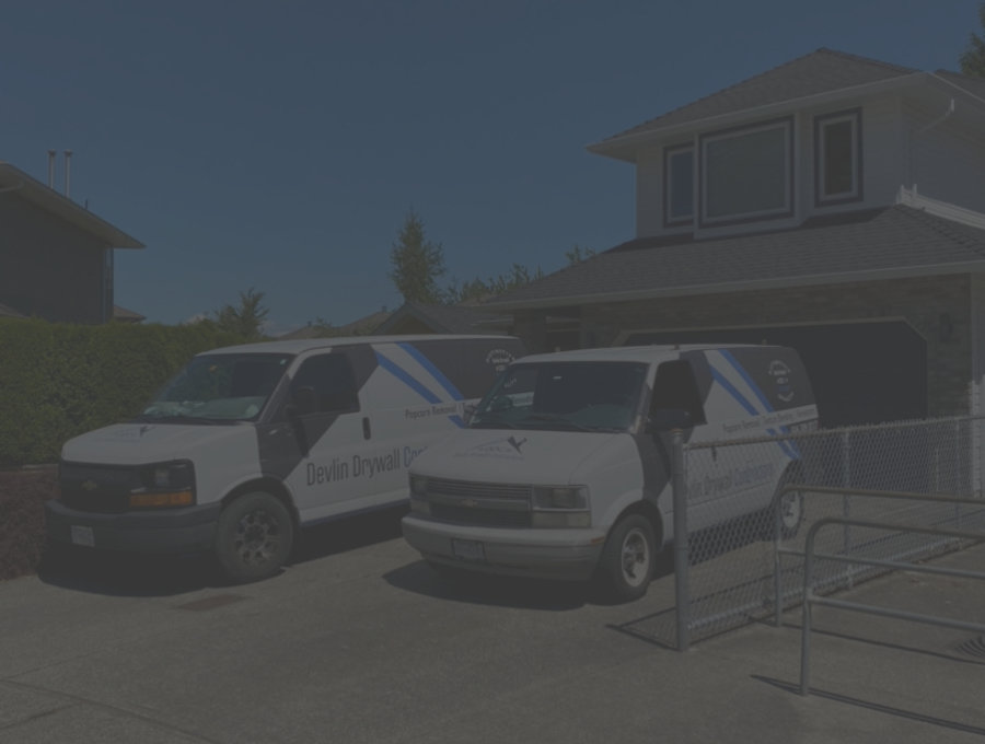 Devlin Drywall Contractors vans on site at a Lower Mainland home
