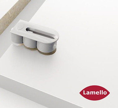Lamello Cabineo cabinet connector fitted into a white panel beside its matching cabinet joint, with the Lamello logo