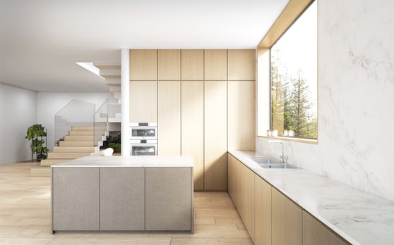Pale oak kitchen cabinets around a rectangular grey island