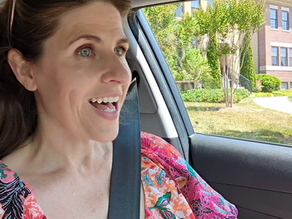 woman driving with a smile on her face