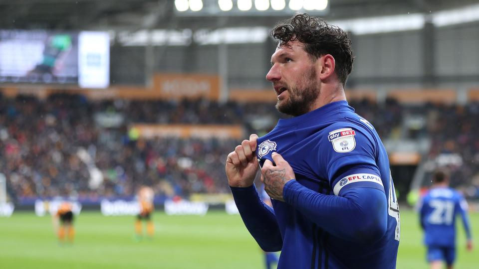 Sean Morrison clutching the Cardiff City badge after scoring a brace against Hull City