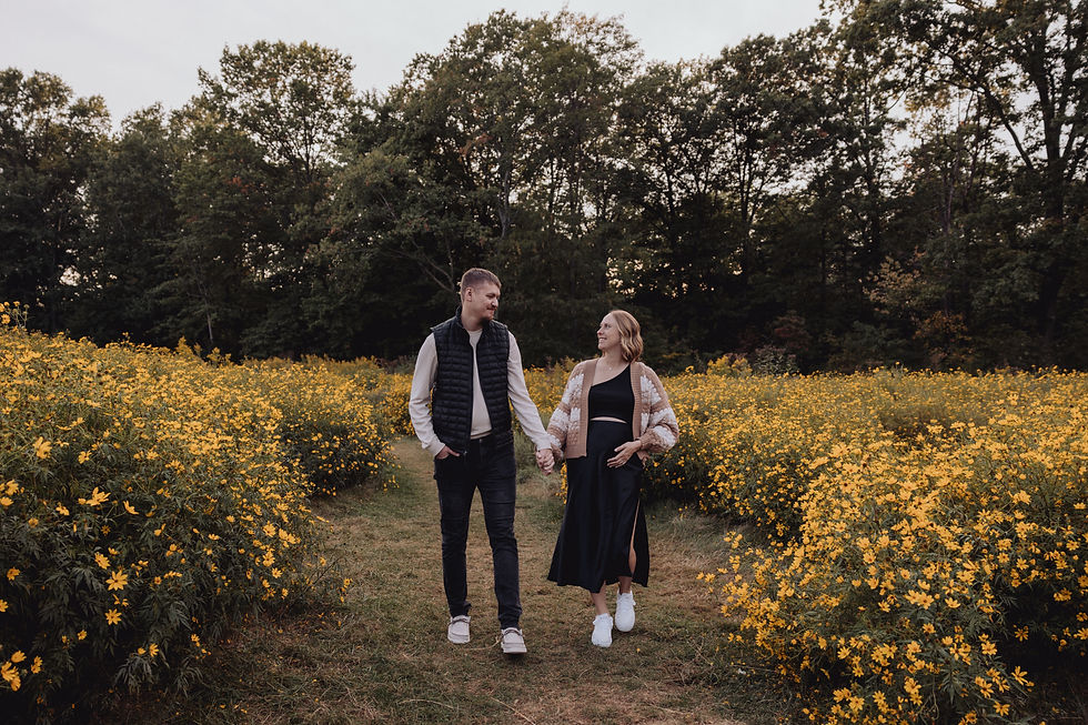 Expecting parents pose in a field of wildflowers in Cleveland, Ohio.