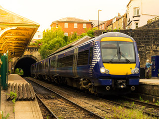 Image shows a railway line and train near houses. Clear Acoustic Design provide a range of environmental noise surveys to comply with the relevant British Standards and planning requirements.