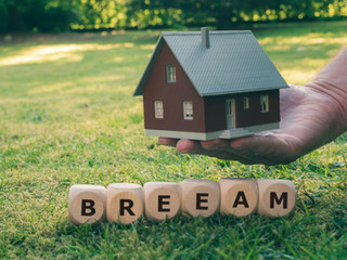 Image shows a house being held in hand in a green field. Clear Acoustic Design provide a range of BREEAM noise surveys to assess and reduce noise levels.