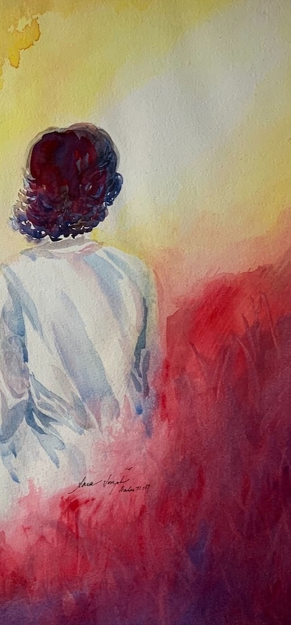 Seated young woman looking into the light.