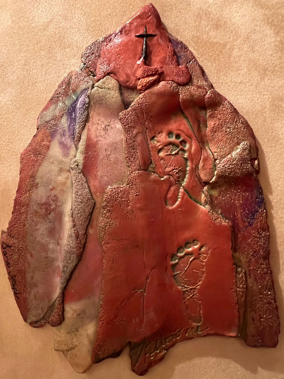 Abstract relief sculpture in polymer clay by Sara Joseph of footprints following a path to the cross of Jesus