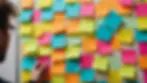 Eye-level view of a collaborative brainstorming session with colorful post-it notes