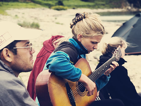 Girl playing guitar outside