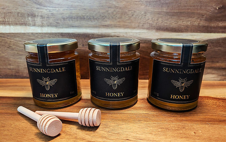3 jars of Sunningdale honey and two honey dippers