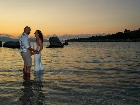 a wedding couple pose in the sea