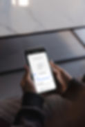 mockuuups-user-holding-an-iphone-in-both-hands-mockup.jpeg