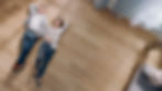 Young Couple are Lying on a Wooden Flooring in an Apartment. They are Happy, Smile and Lau