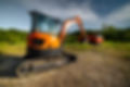 vecteezy_bulldozer-stands-on-a-piece-of-land-against-the-backdrop-of_51215586.jpg