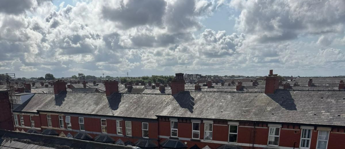 Rows of Blackpool rooftops seen from a flat roof under repair