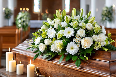 vecteezy_white-flowers-and-candles-adorning-coffin-during-funeral_75232088.jpg