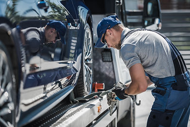 vecteezy_tow-truck-driver-securing-loaded-car-for-safe-delivery_24526198.jpg