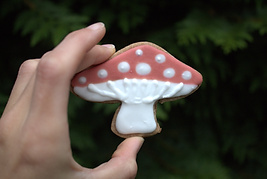 chai cookie with vanilla royal icing in the shape of a mushroom
