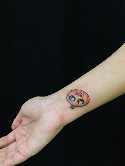 Cartoon pumpkin tattoo at Tattoo shop Oshawa near Pickering Ajax and Whitby