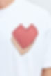 Close-up of a red and orange heart shape patch design on a Ziggi t-shirt