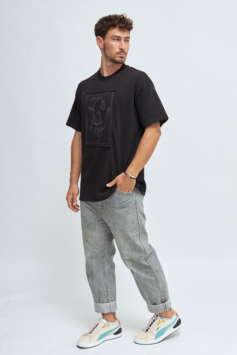 Thumbnail: Man modeling black T-shirt with logo