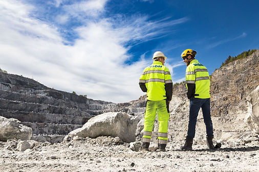 Two men on a mine site wearing Robit High Vis Vests using Robit products supplied by Just Drill in the UK and Ireland