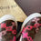 Thumbnail: Angled pair of Louis Vuitton Monogram Boat Sneakers styled on branded box with dustbag showing with monogram detail and soles