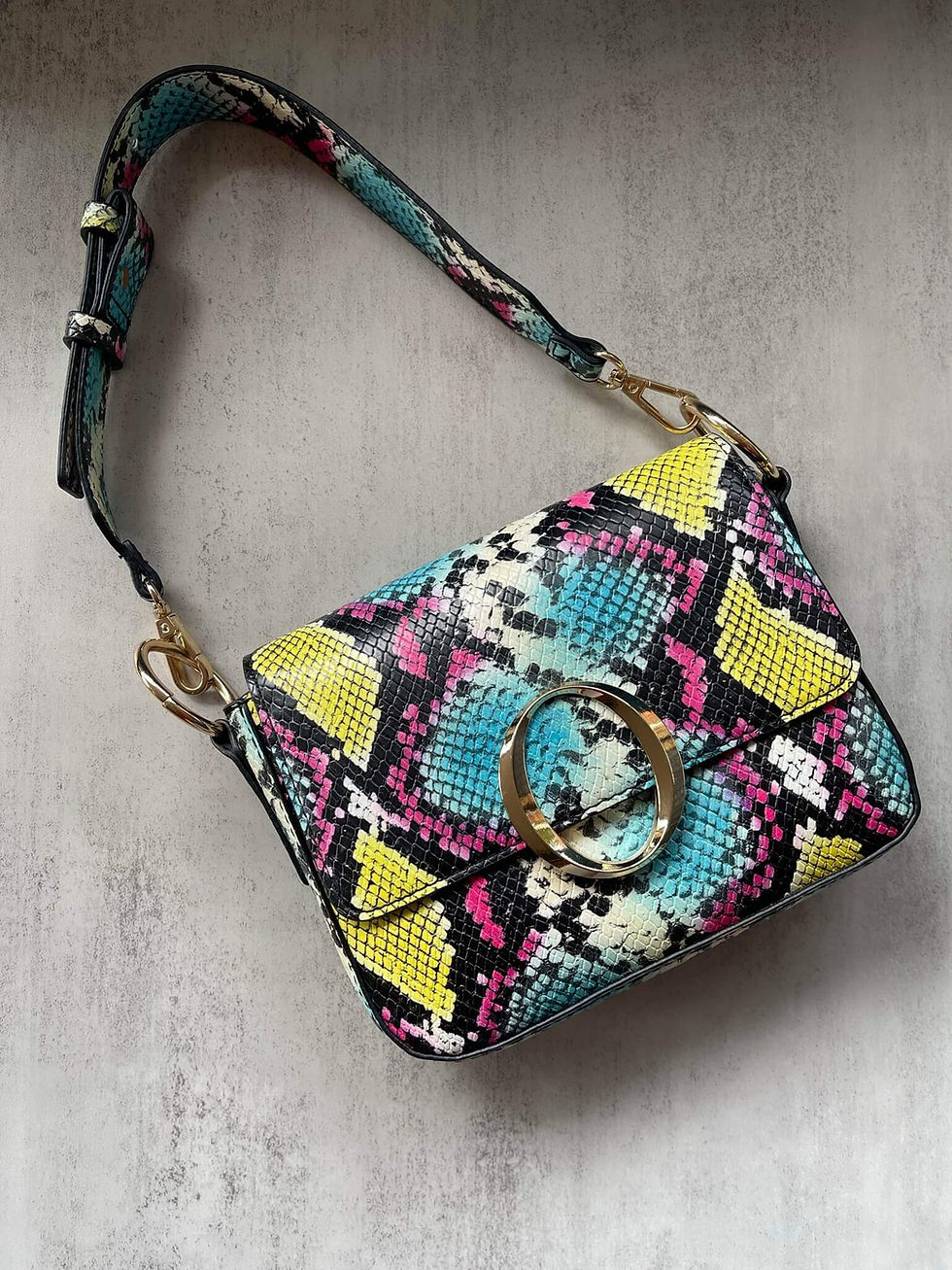 Aldo Multi-Colour Snake Print Handbag – angled front view with bold textured finish, gold ring detail, and top handle