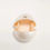 Thumbnail: Open container holding a block of butter against a white background.