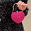Миниатюра: Woman holding a bright pink heart-shaped clutch bag, LUV RUSH.