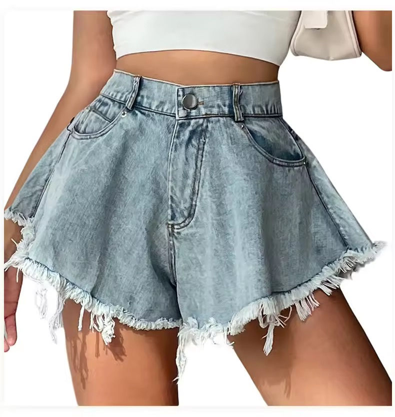 Thumbnail: Woman wearing denim shorts with frayed edges and a white top.