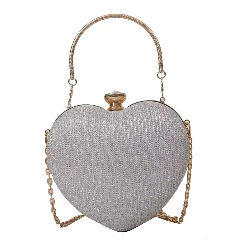 Прев'ю: Glittering heart-shaped handbag with gold accents and chain strap, elegant design.