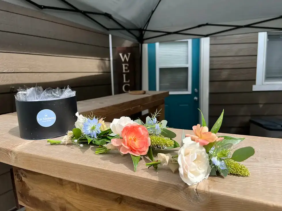 Pretty flowers and gift box on a bar