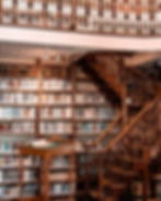 Grand wooden library, bookshelves, staircase