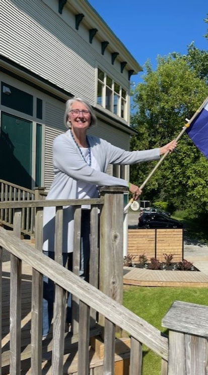 Woman holding OREA flag outside Home