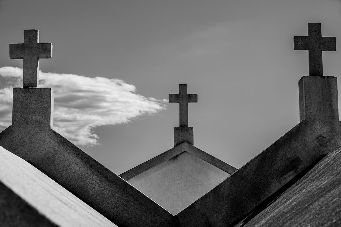 Croix sur le toit d'une église, ciel nuageux.