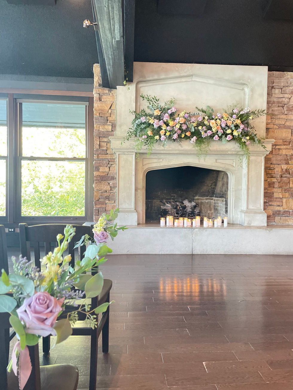 Ornate fireplace decorated with flowers for wedding ceremony
