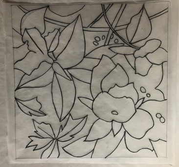 Tracing the lines on the back of the tracing paper with a charcoal