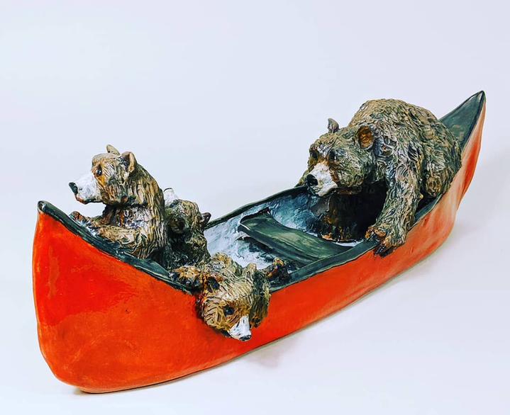 Ceramic bear family canoe sculpture