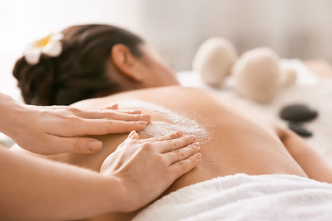 young-woman-undergoing-treatment-with-body-scrub-spa-salon.jpg