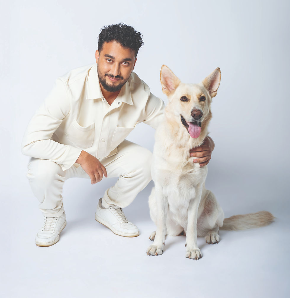 Man crouching with a white dog