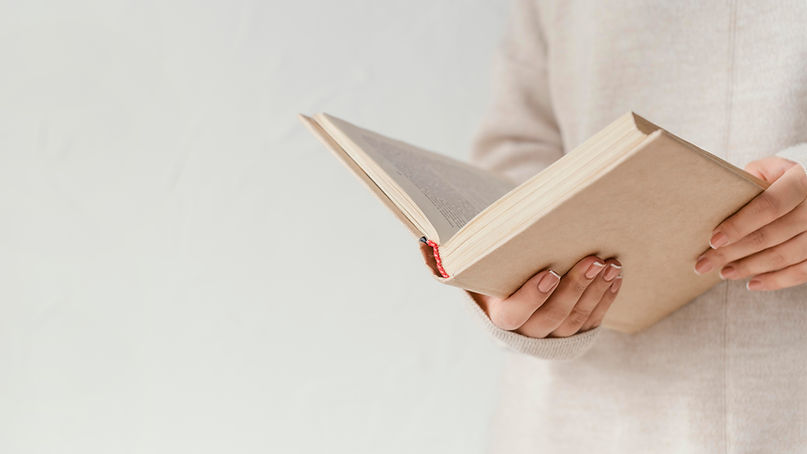 close-up-hands-holding-open-book.jpg